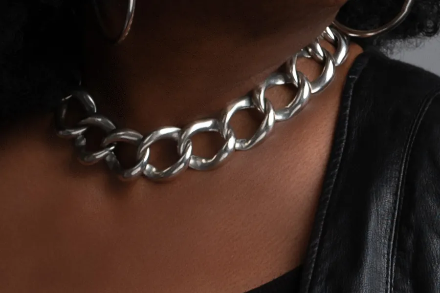 Detail: a heavy silver chain at the collar