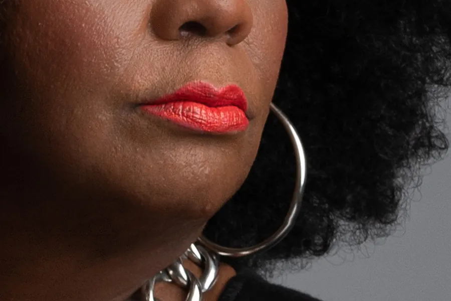 Detail: lips and a silver hoop earring